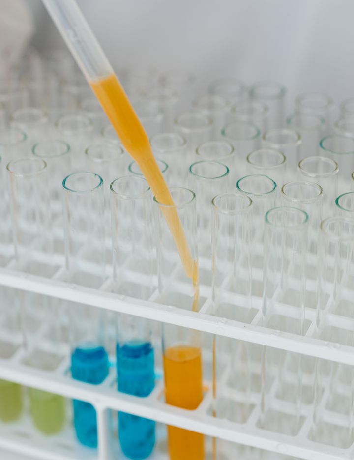 Pipette dropping a sample into test tubes