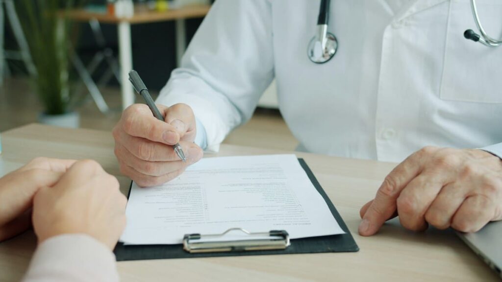 Doctor's desk with notes during a confidential consultation after a condom broke on Koh Samui