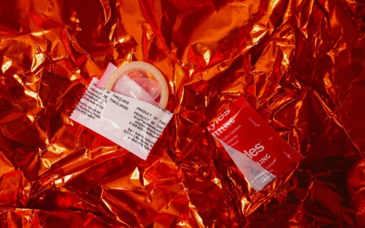 Condom packets on red foil, illustrating what to do when a condom broke on Koh Samui