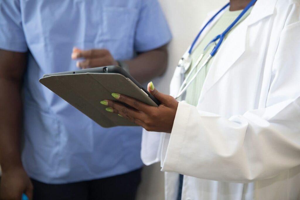 Hands holding a printed lab report showing an HIV test result after PEP follow-up