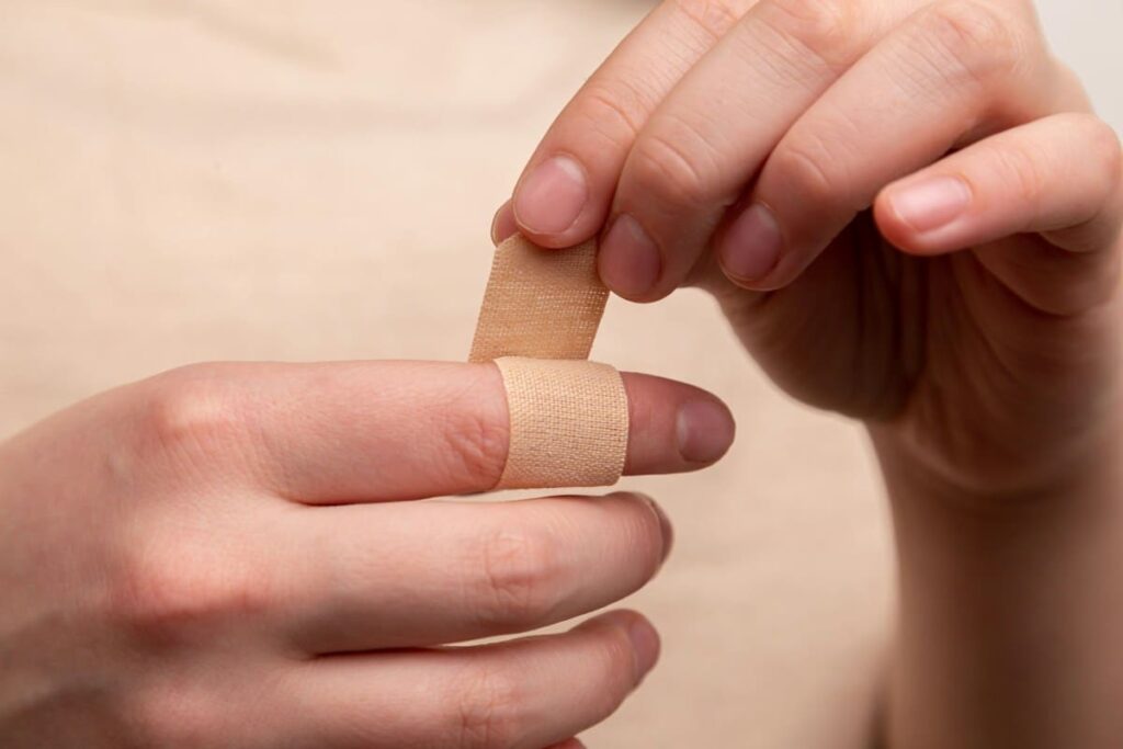 Small bandage on a fingertip after a finger-prick blood test for HIV
