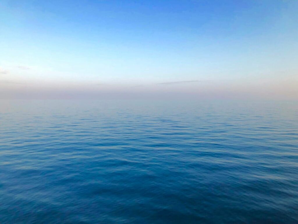 Calm sunrise over the sea, a quiet moment during week three of a 28-day PEP course