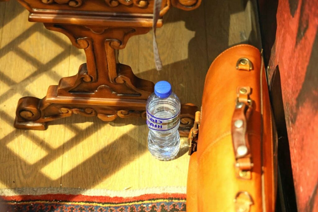 Travel day bag with a water bottle and pill case, packed for taking PEP daily while on holiday