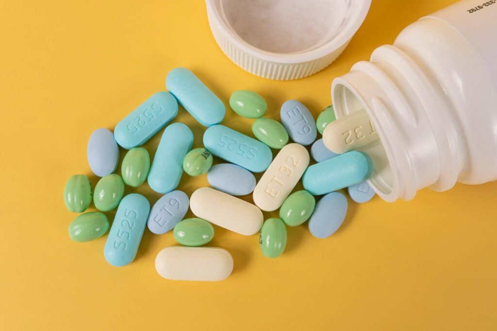Capsules spilling from a pill bottle, representing how PEP effectiveness depends on starting within 72 hours