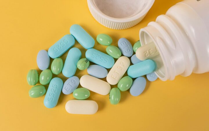Capsules spilling from a pill bottle, representing how PEP effectiveness depends on starting within 72 hours