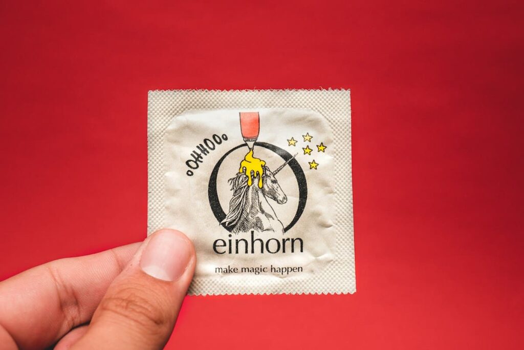 Unopened condom packet on a wooden table, a reminder of safer sex before the Full Moon Party