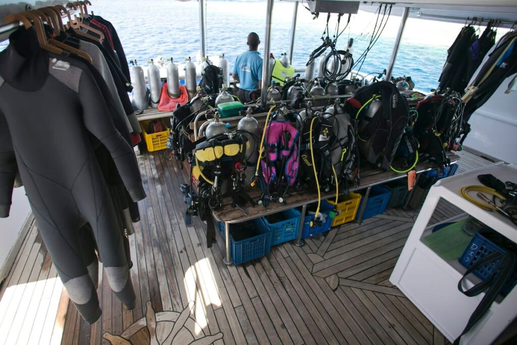 Scuba diving equipment drying on a wooden dock, reflecting island life for divers who may need PEP or STD tests