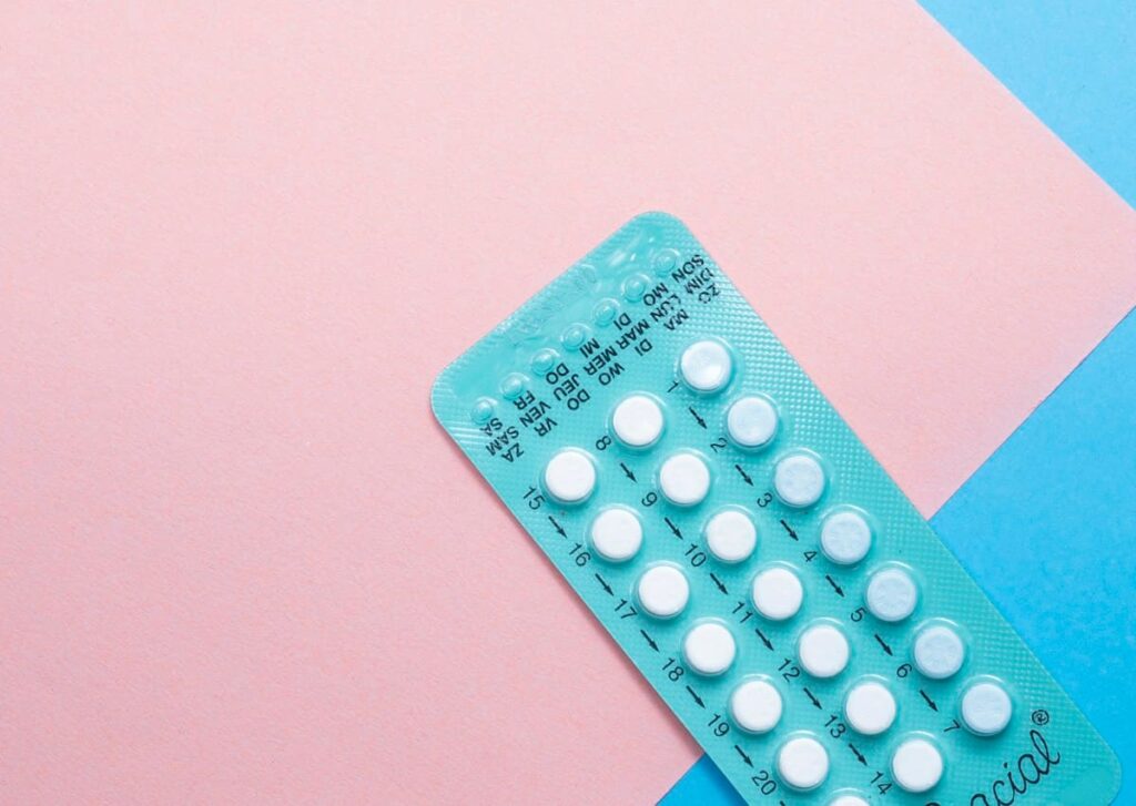 Calendar beside a strip of contraceptive pills, relevant to PEP side effects and planning for women