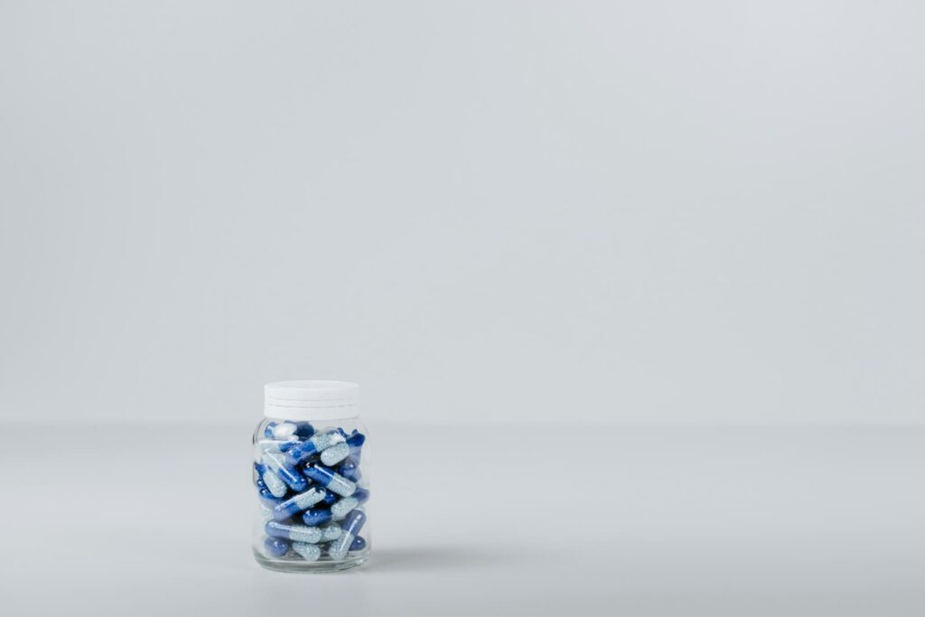 Bottle of blue and white tablets, illustrating the cost of HIV PrEP on Koh Samui