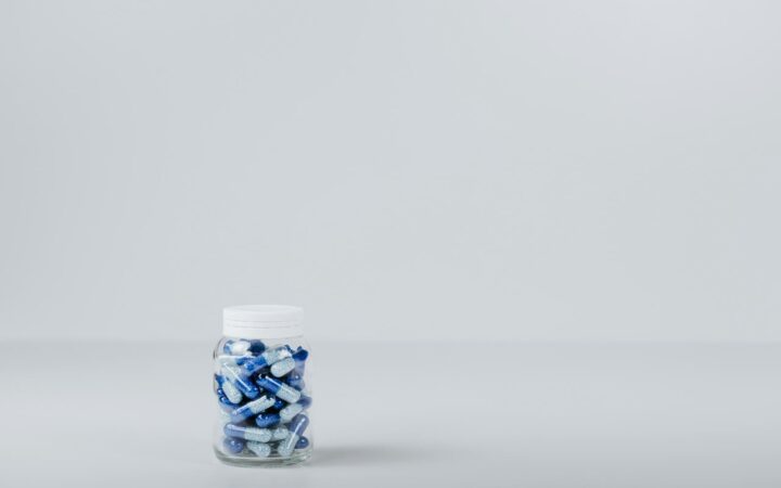 Bottle of blue and white tablets, illustrating the cost of HIV PrEP on Koh Samui