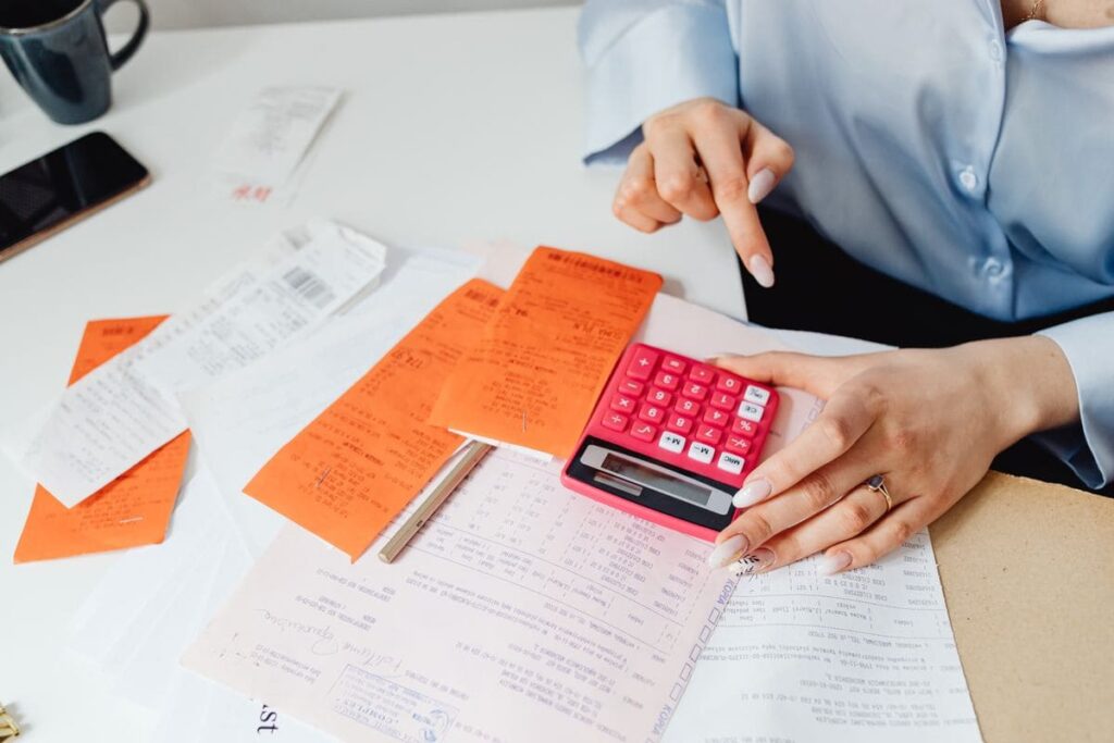 Calculator and receipt on a counter, a reminder to check hidden costs when comparing PrEP prices