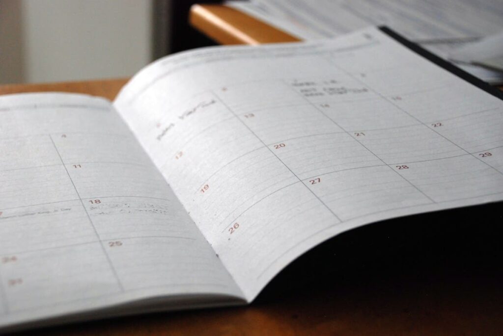 Desk calendar and notebook for planning when to book an STD test on Koh Samui after a new partner