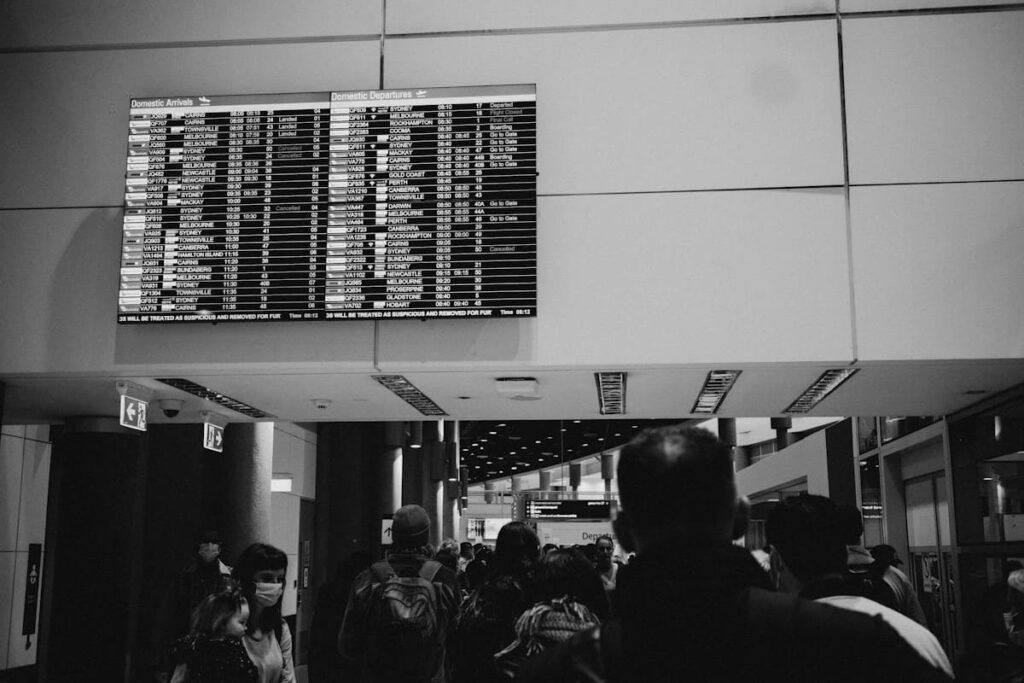 Airport departure board listing flights, a reminder to plan STD testing after travel to Thailand