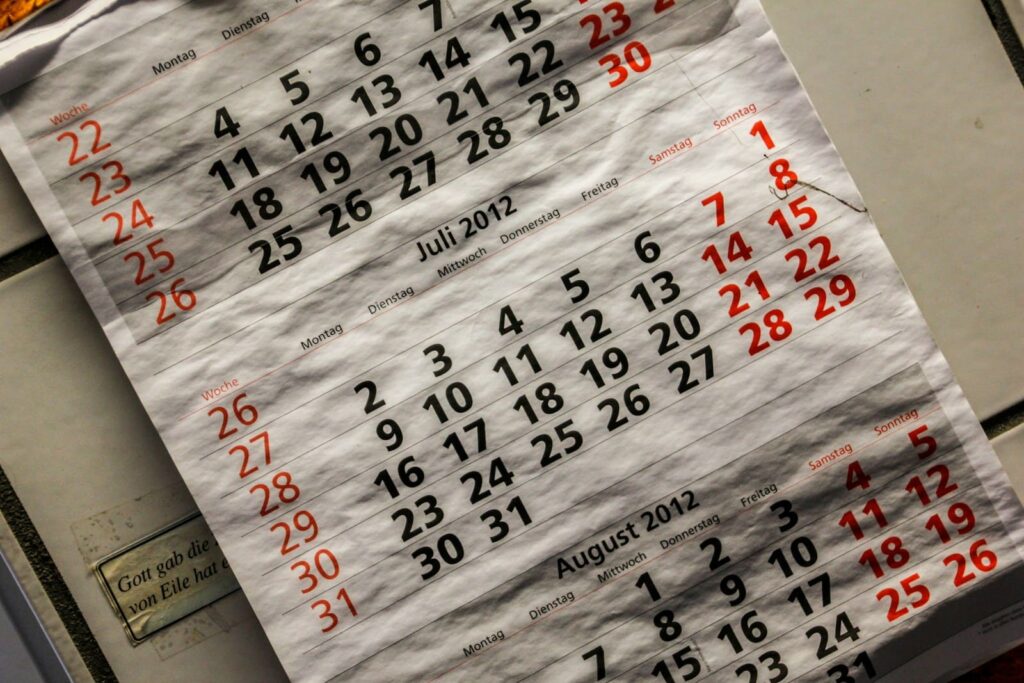 Wall calendar with dates circled in red, representing planning when to get an STD test after unprotected sex