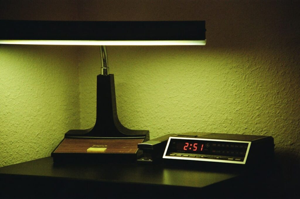 Digital clock glowing on a nightstand, a reminder that PEP after unprotected sex is time-critical