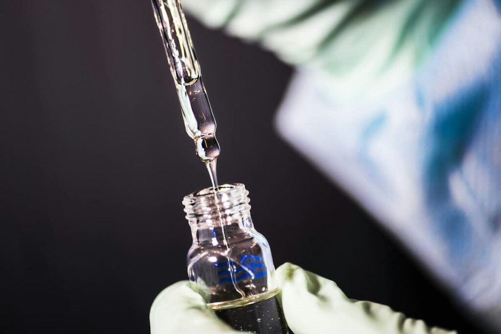 Pipette placing a blood sample onto a test plate, as used in rapid syphilis testing