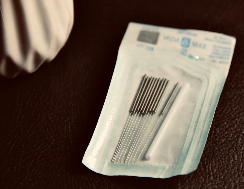 Close-up of sealed single-use needle packets, the most important check for bamboo tattoo safety